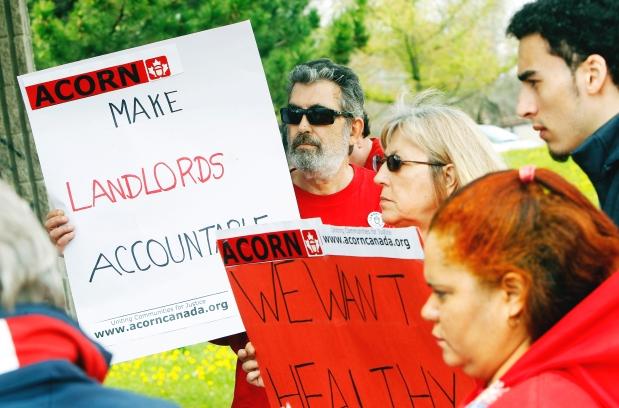 ACORN members show their support during a rally at Sandalwood Park on Wednesday to press the City of Ottawa for better housing standards.  